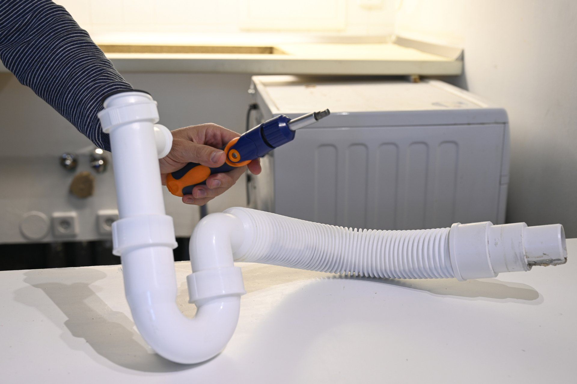 Man Holding a Screwdriver in His Hand — Reisterstown, MD — JJ's Plumbing & Drain Services, LLC.