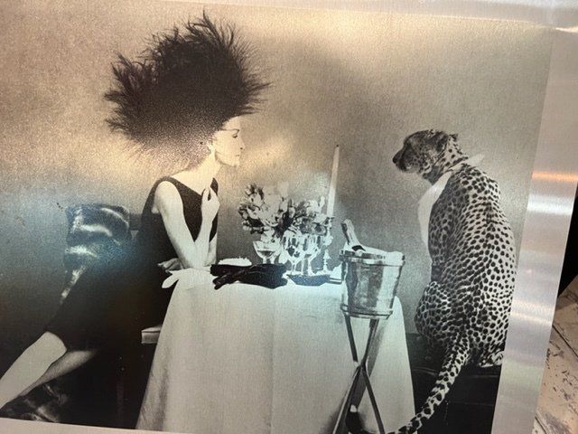 A black and white photo of a woman and a cheetah
