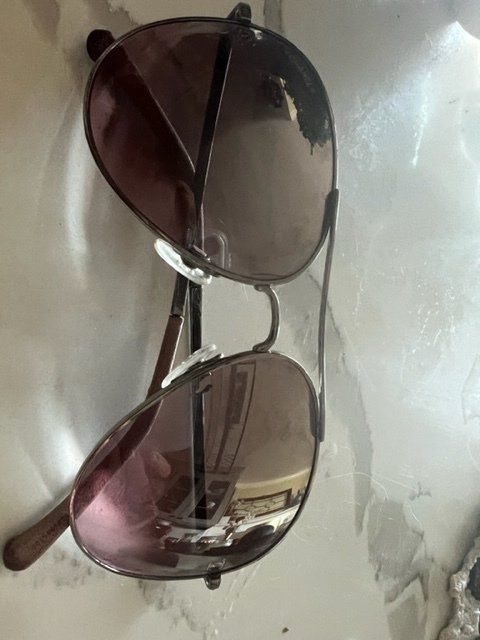 A pair of sunglasses are sitting on a table.