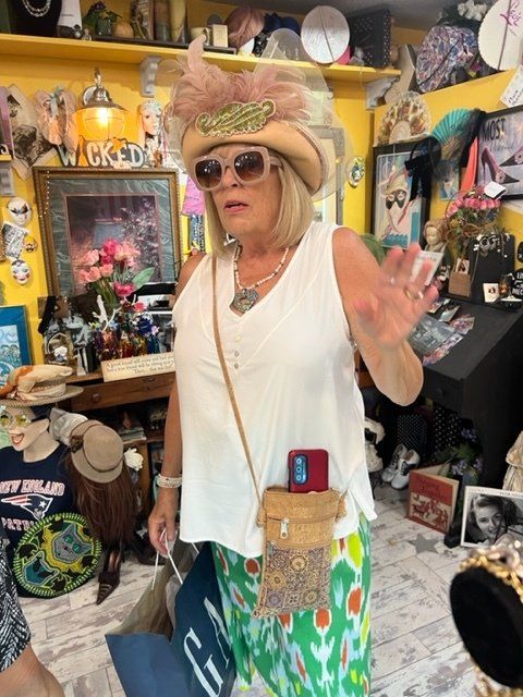 A woman wearing a hat and sunglasses in a store