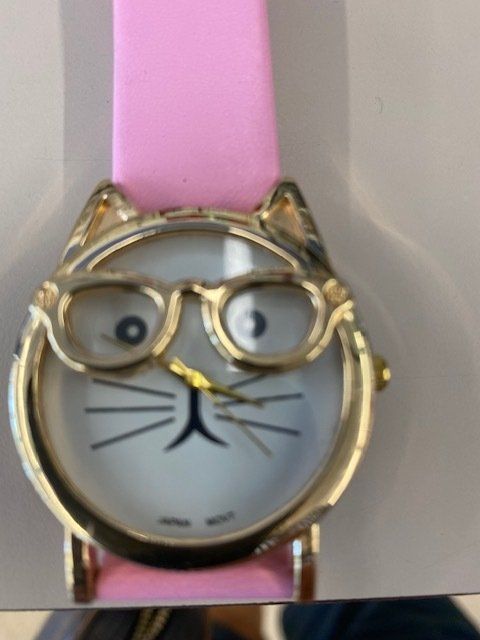 A watch with a cat face and glasses on it