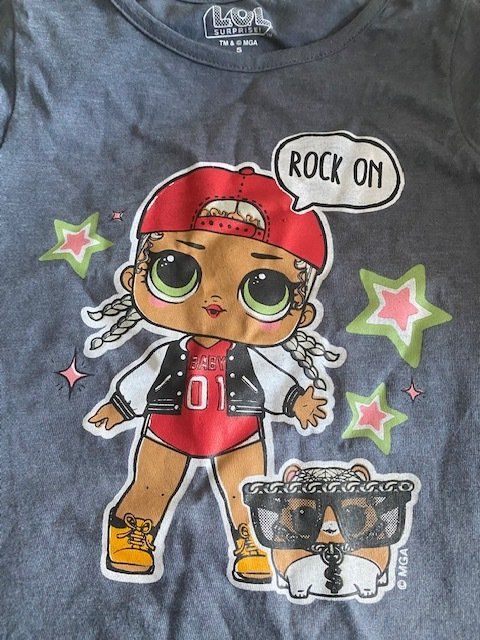 A t-shirt with a lol doll on it that says rock on