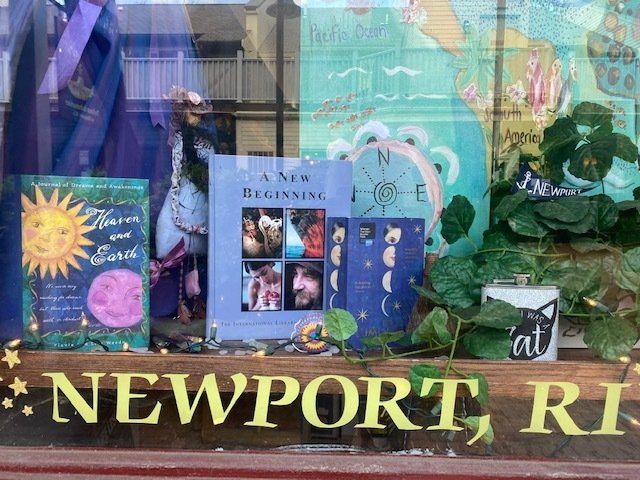 A book called a new beginning is on display in a store window