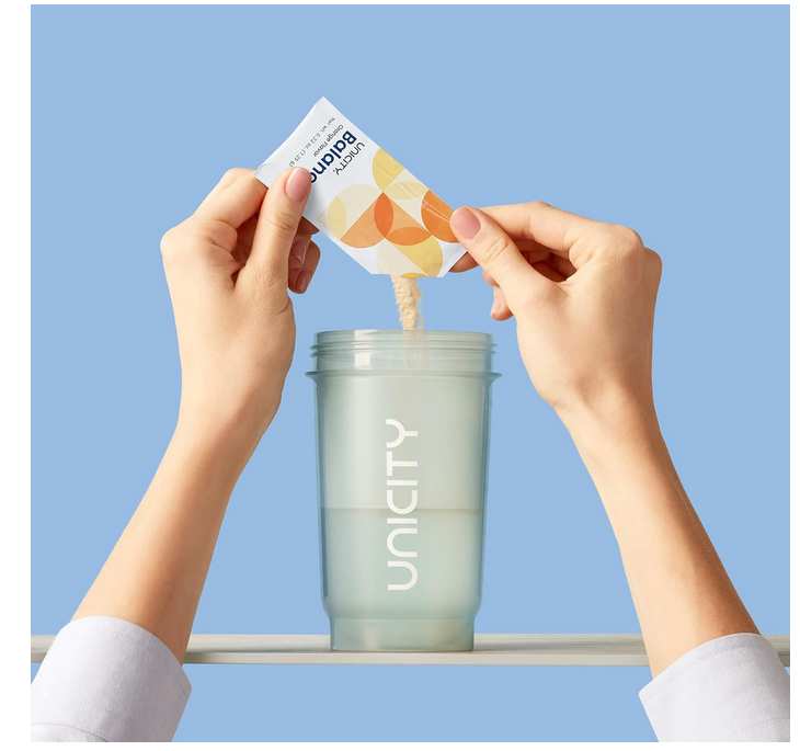 A person is pouring something into a unity cup