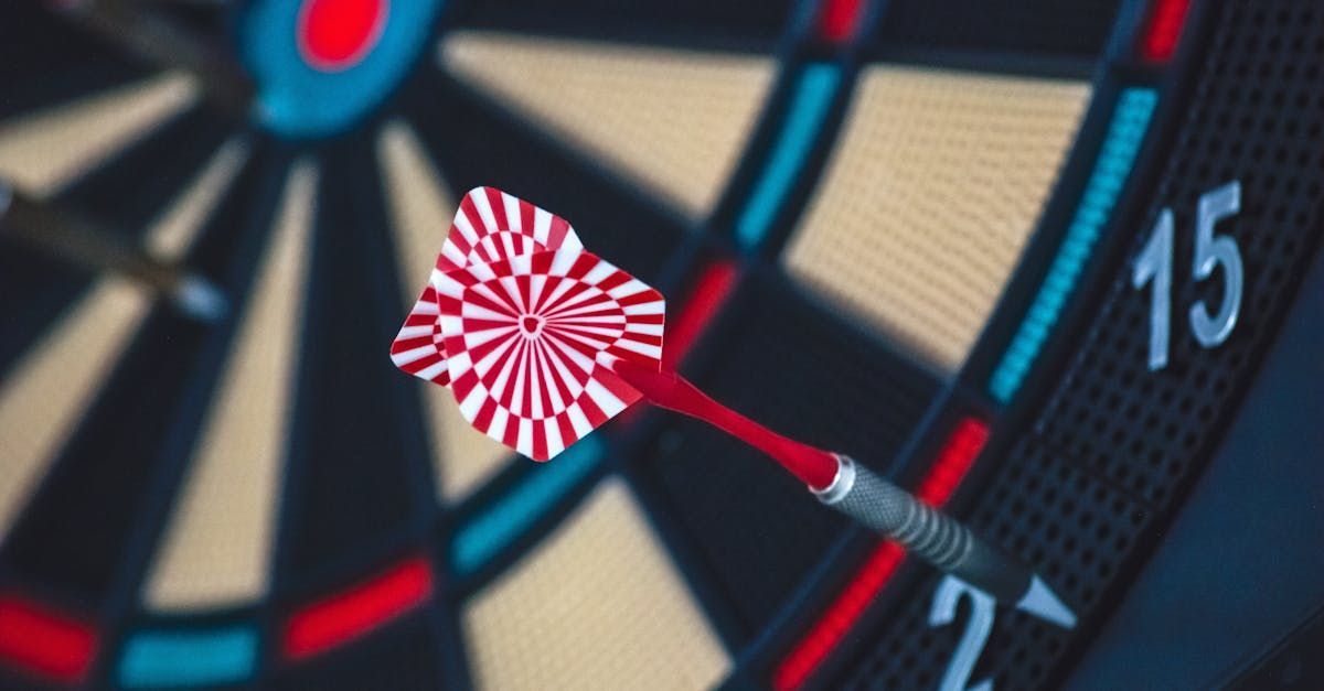 A dart is hitting the center of a dart board