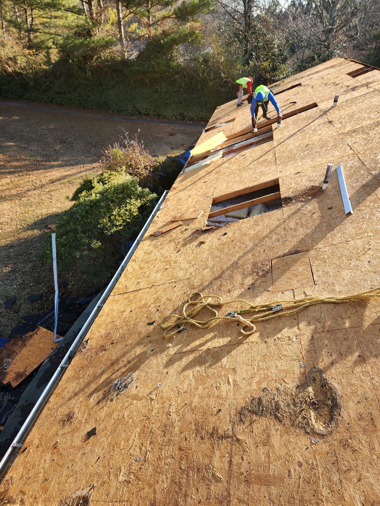 A man is working on the roof of a house.