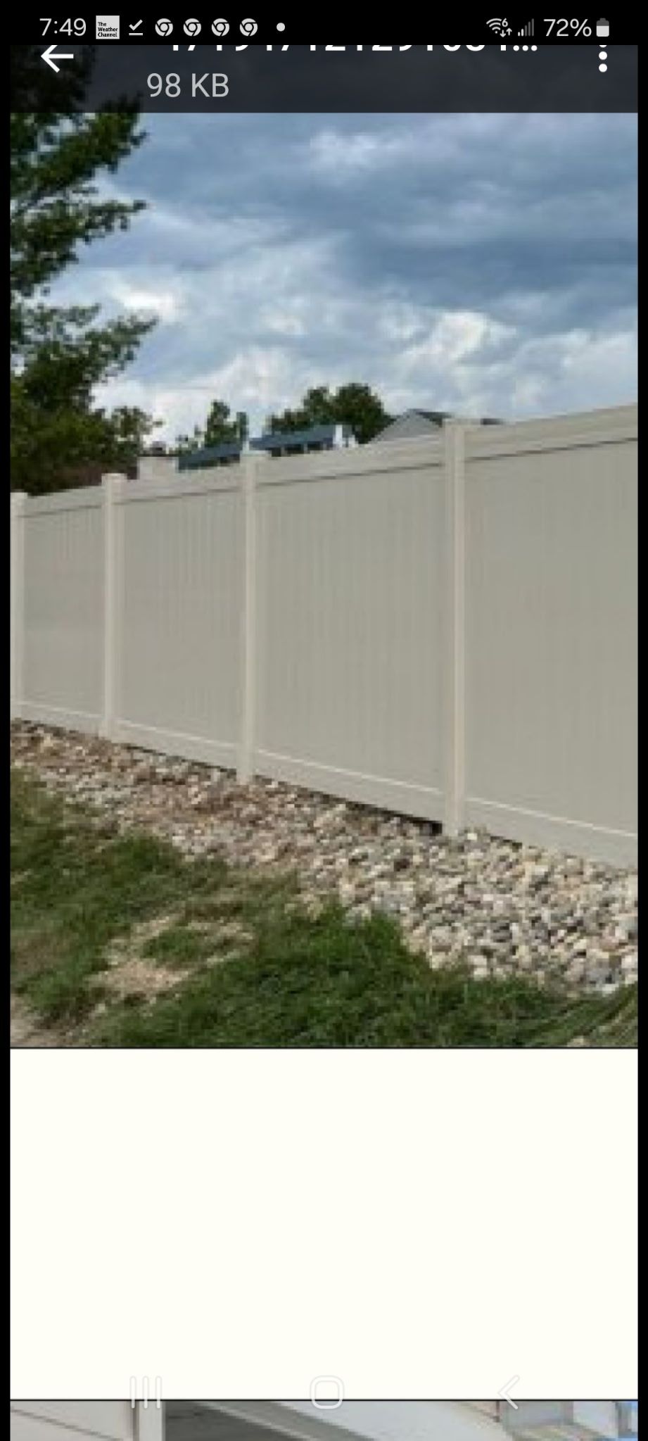 A picture of a white fence on a cell phone.
