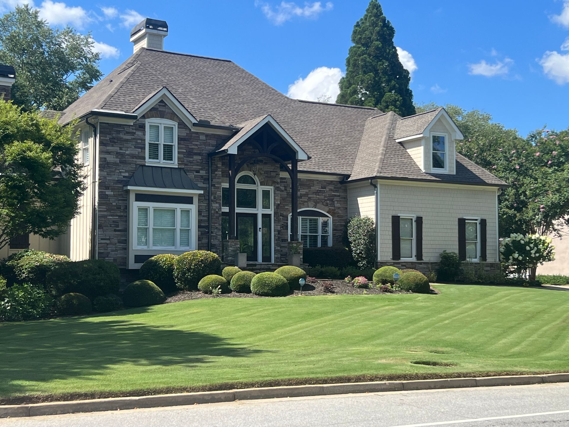 A large house with a lush green lawn in front of it