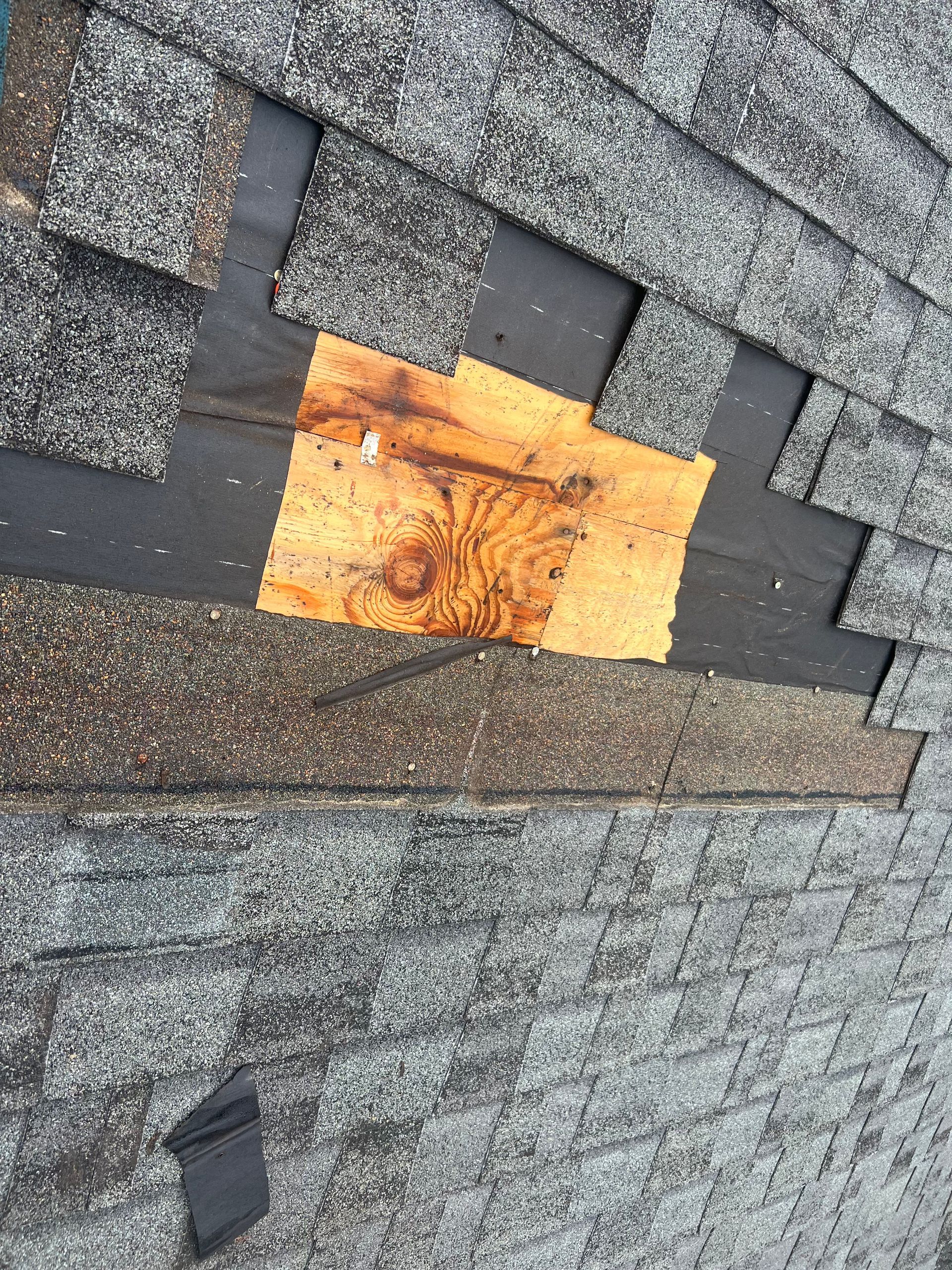 A close up of a roof with a piece of wood sticking out of it.