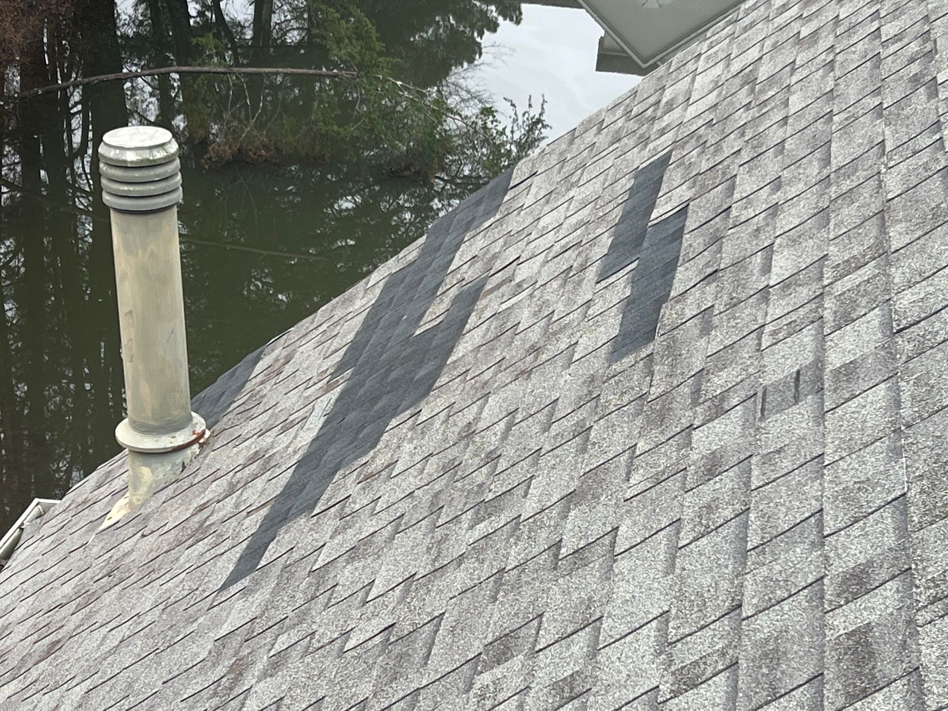 A close up of a roof with a chimney on top of it.