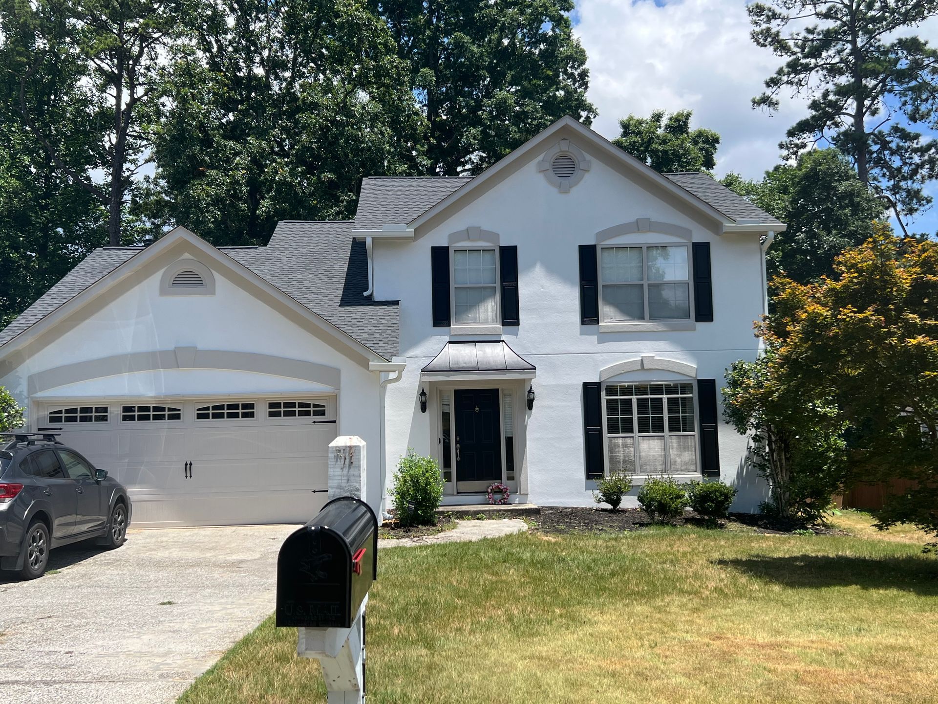A close up of a gray shingle roof on a house.