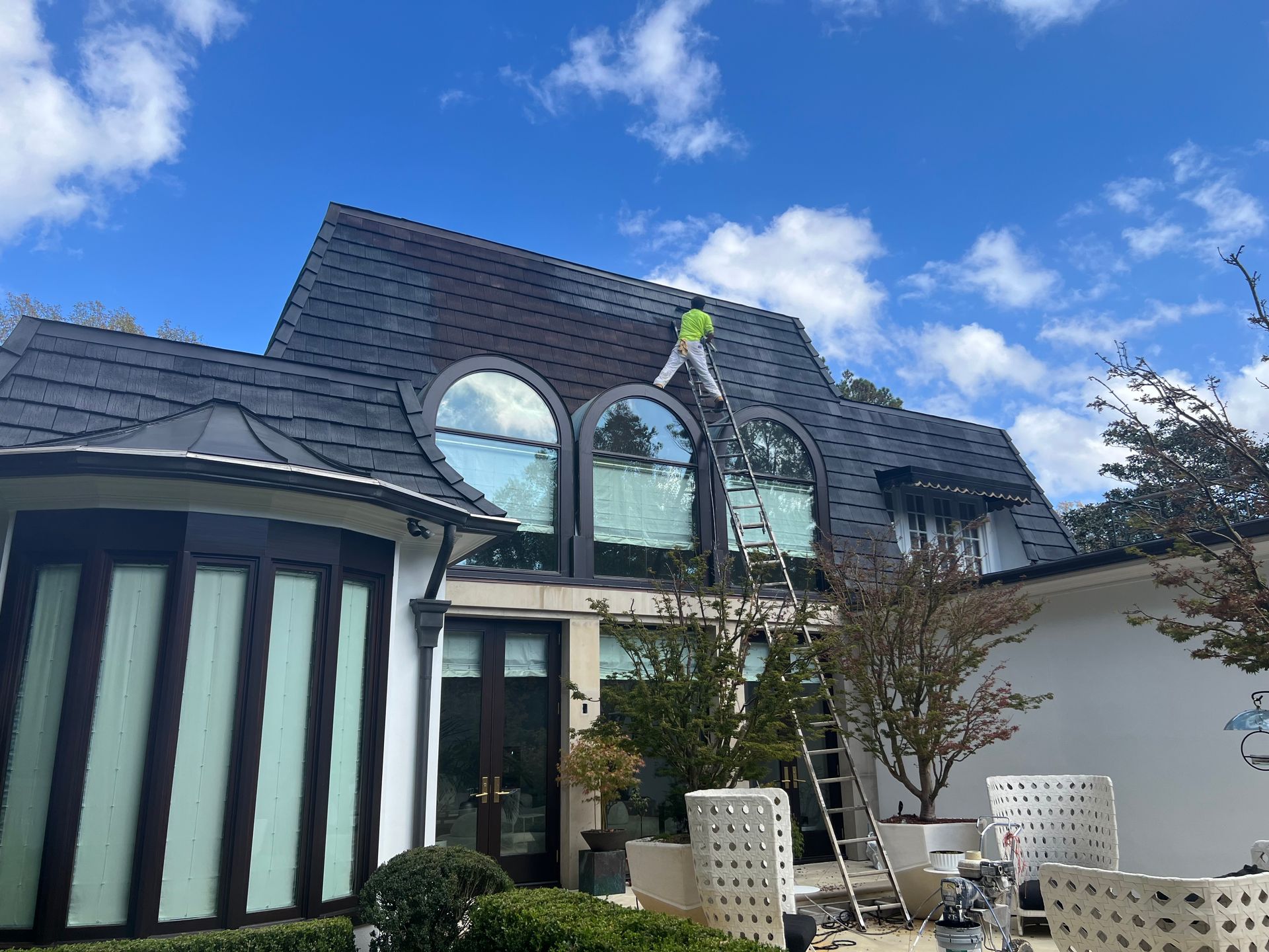 A large white house with a car parked in front of it