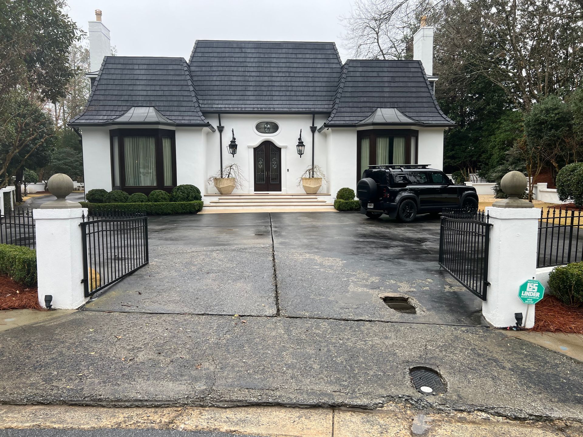 A close up of a gray shingle roof on a house.