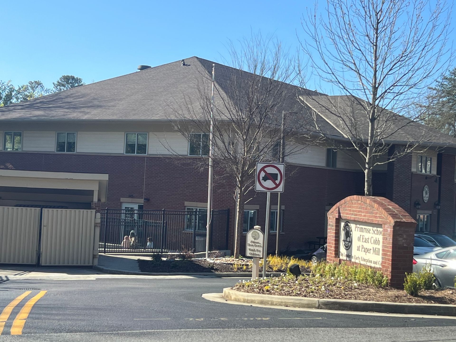 A large brick building with a no parking sign in front of it