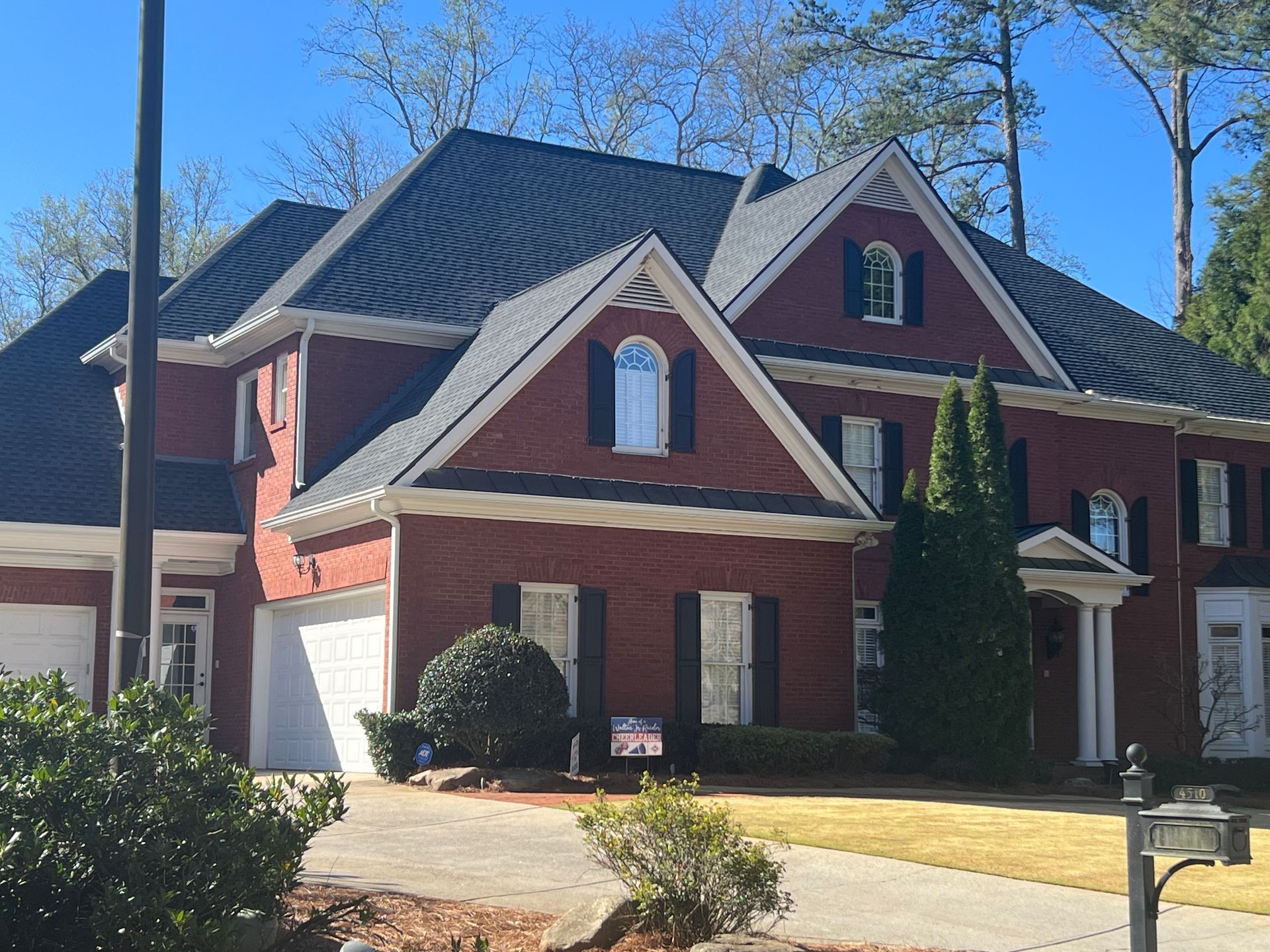 A large white house with a car parked in front of it