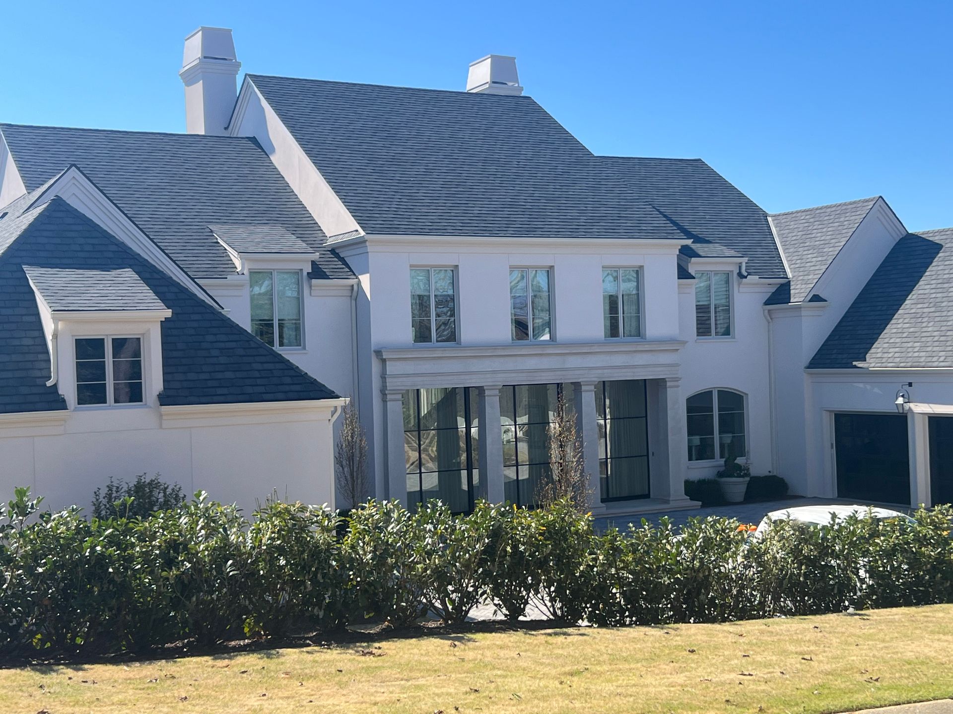 A large white house with a black roof