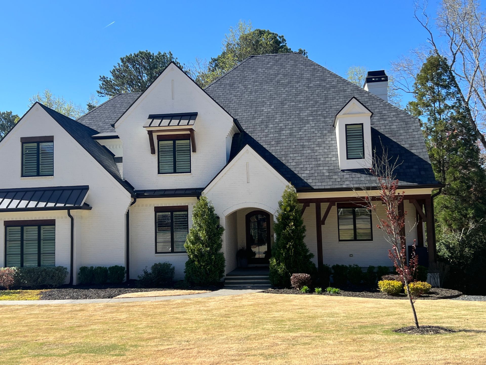 A large white house with a black roof