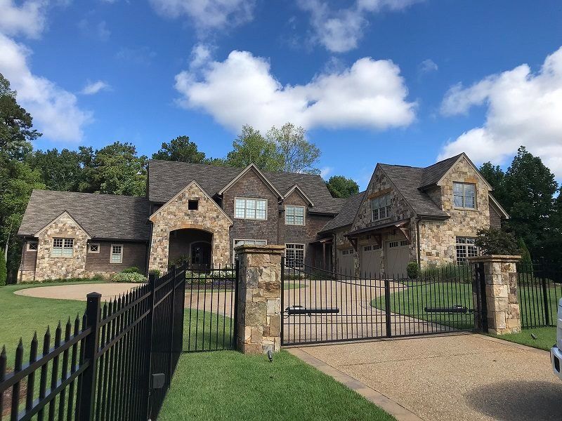 A large house with a black fence around it