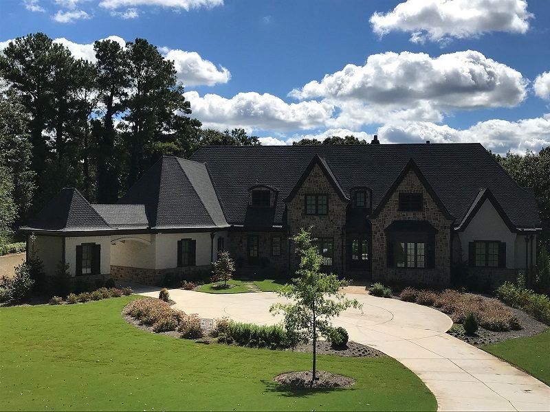 A large house with a driveway leading to it