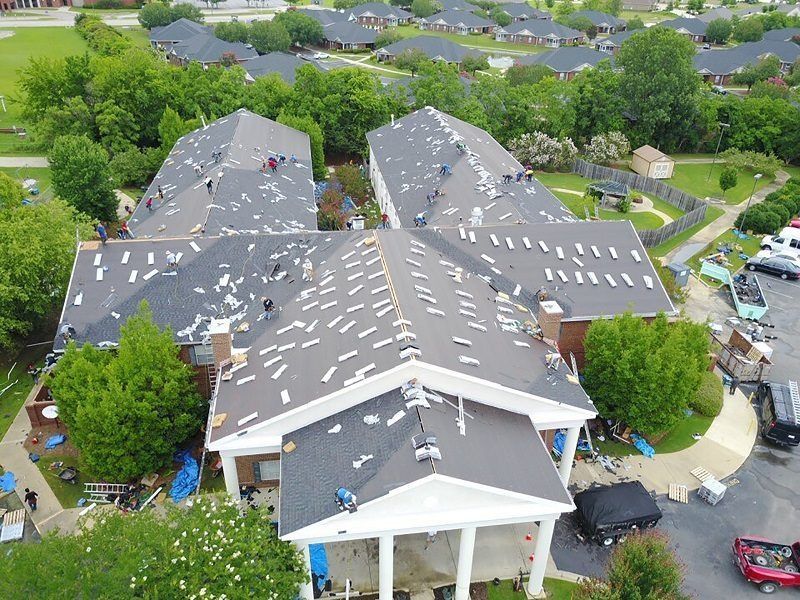 An aerial view of a residential area with a lot of houses and trees.