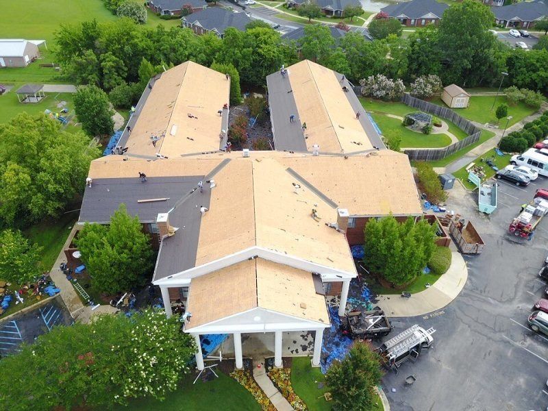 An aerial view of a building with a lot of roofs