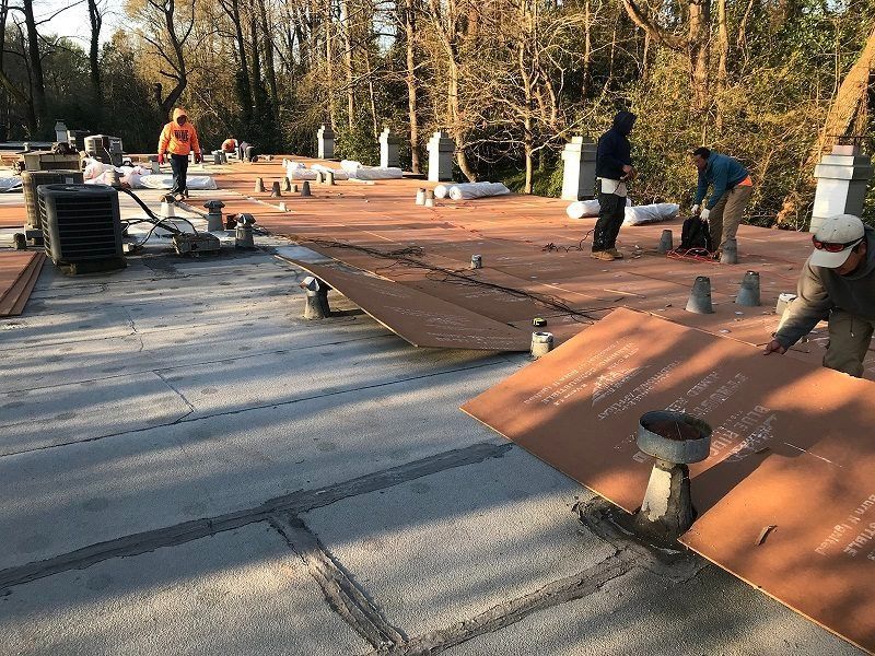 A group of people are working on a roof.