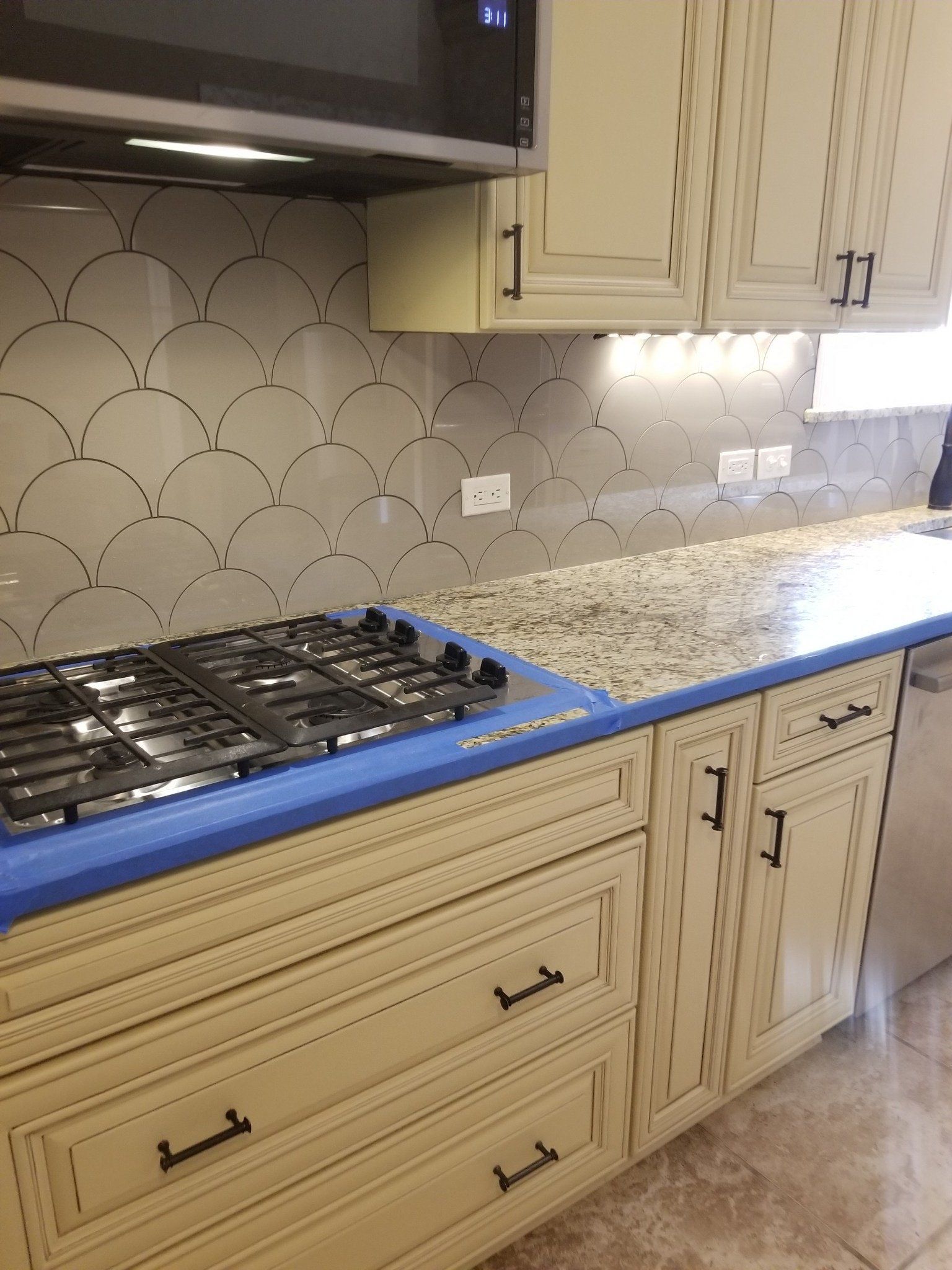 A kitchen with a stove top oven and a microwave.