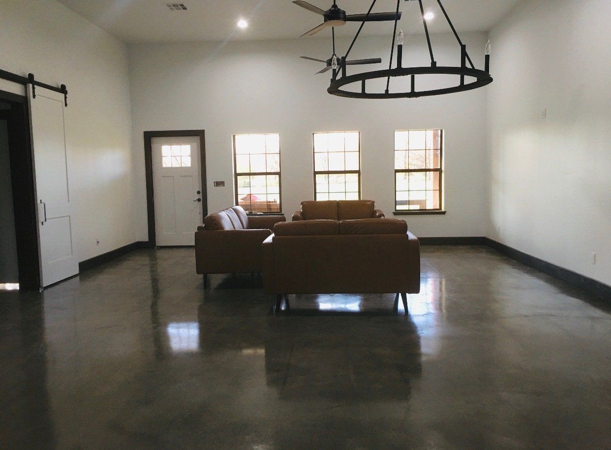 A living room with a lot of furniture and a chandelier