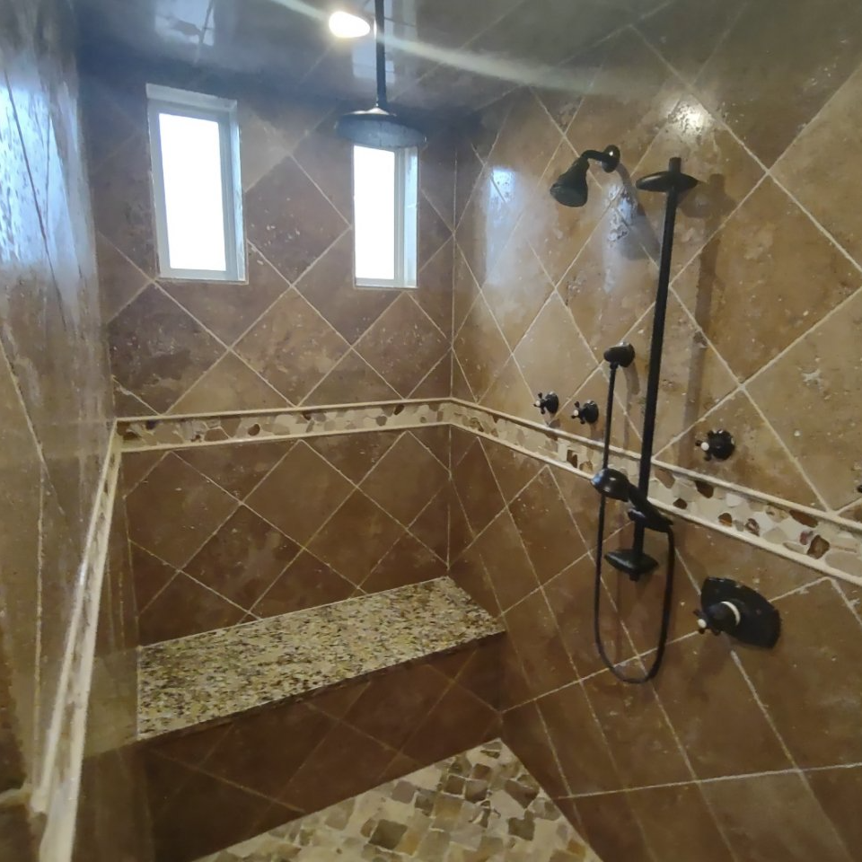 Marble tile shower, shower seat and tiled ceiling