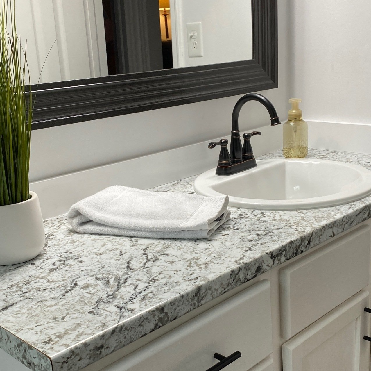 Bathroom sink, cabinet, mirror and counter top