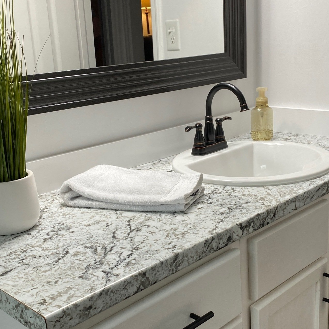 Remodeled bathroom, sink, countertop and cabinet.