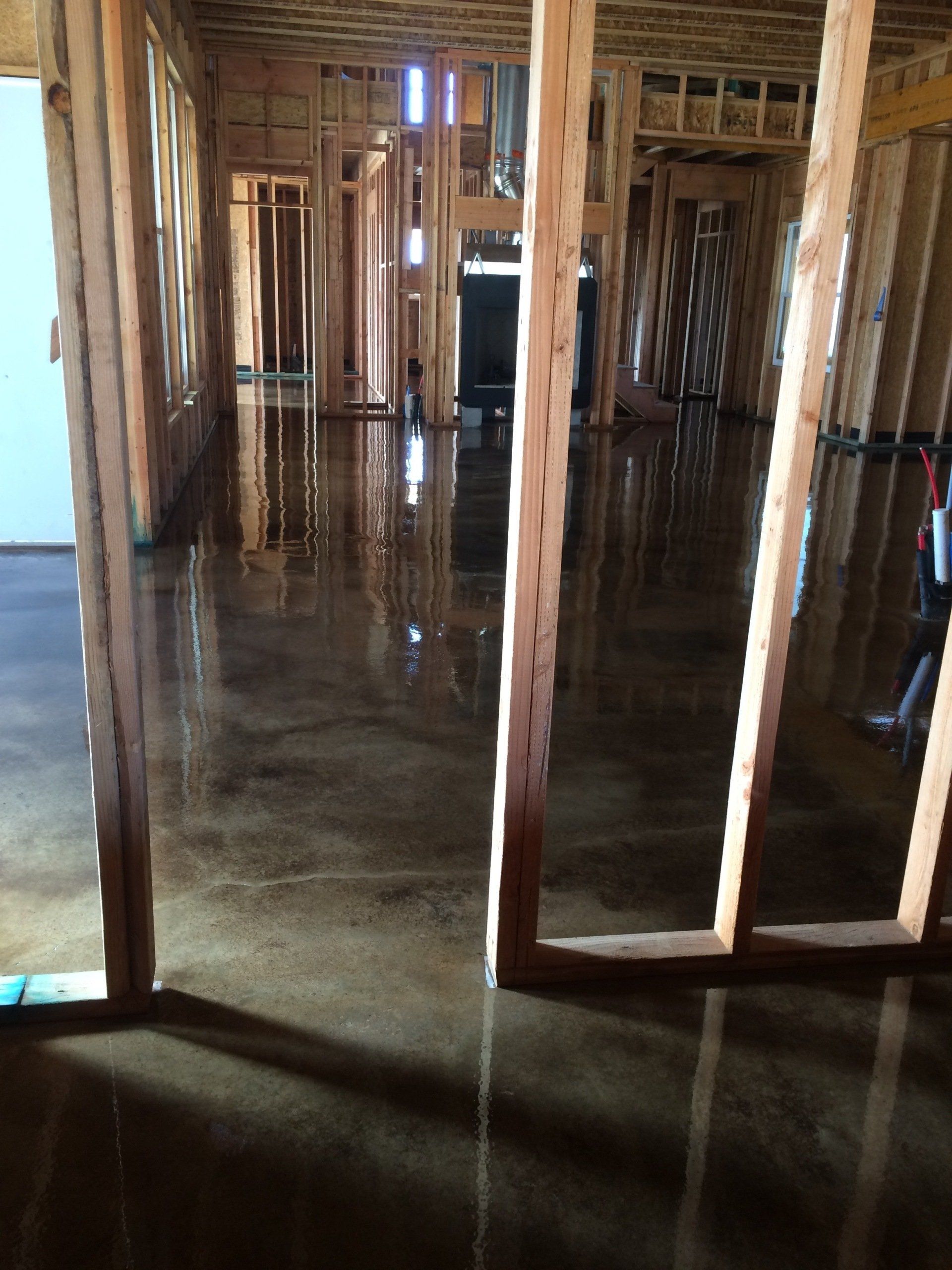 The inside of a house under construction with a concrete floor