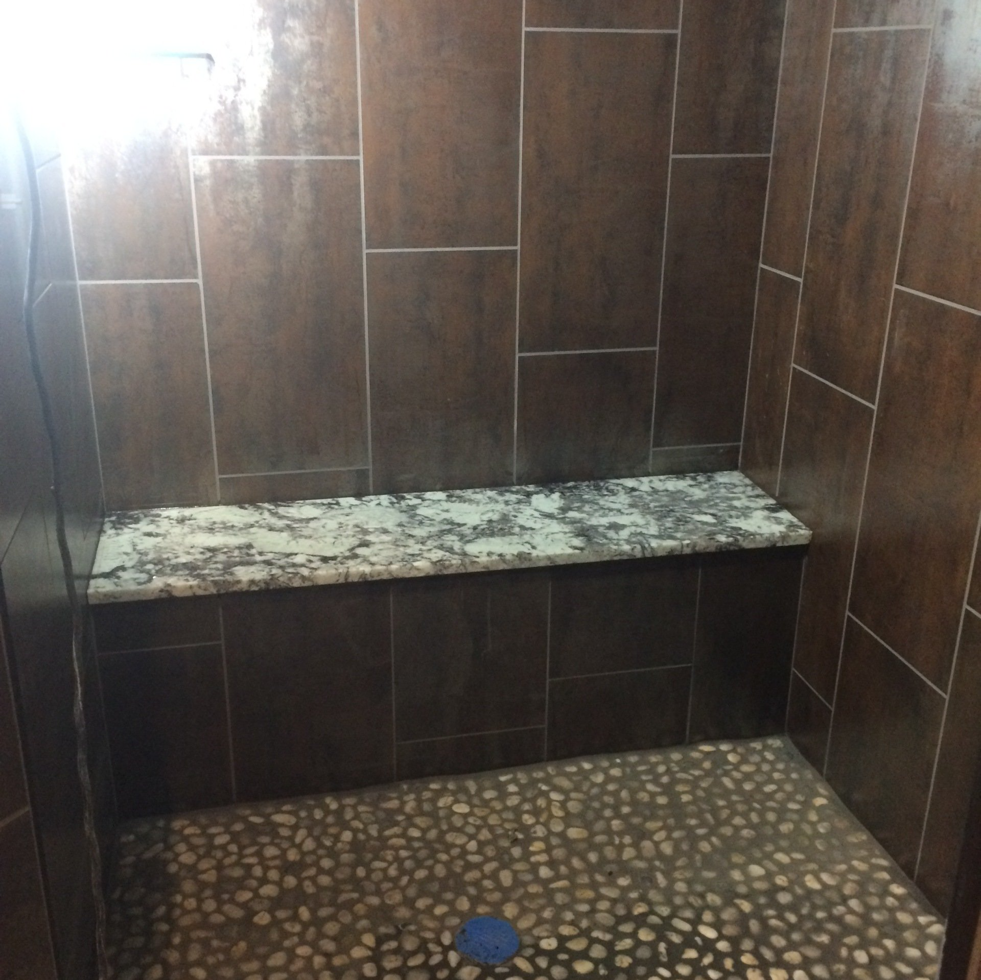 Awesome shower installed, shower bench seat, tile stacked vertical