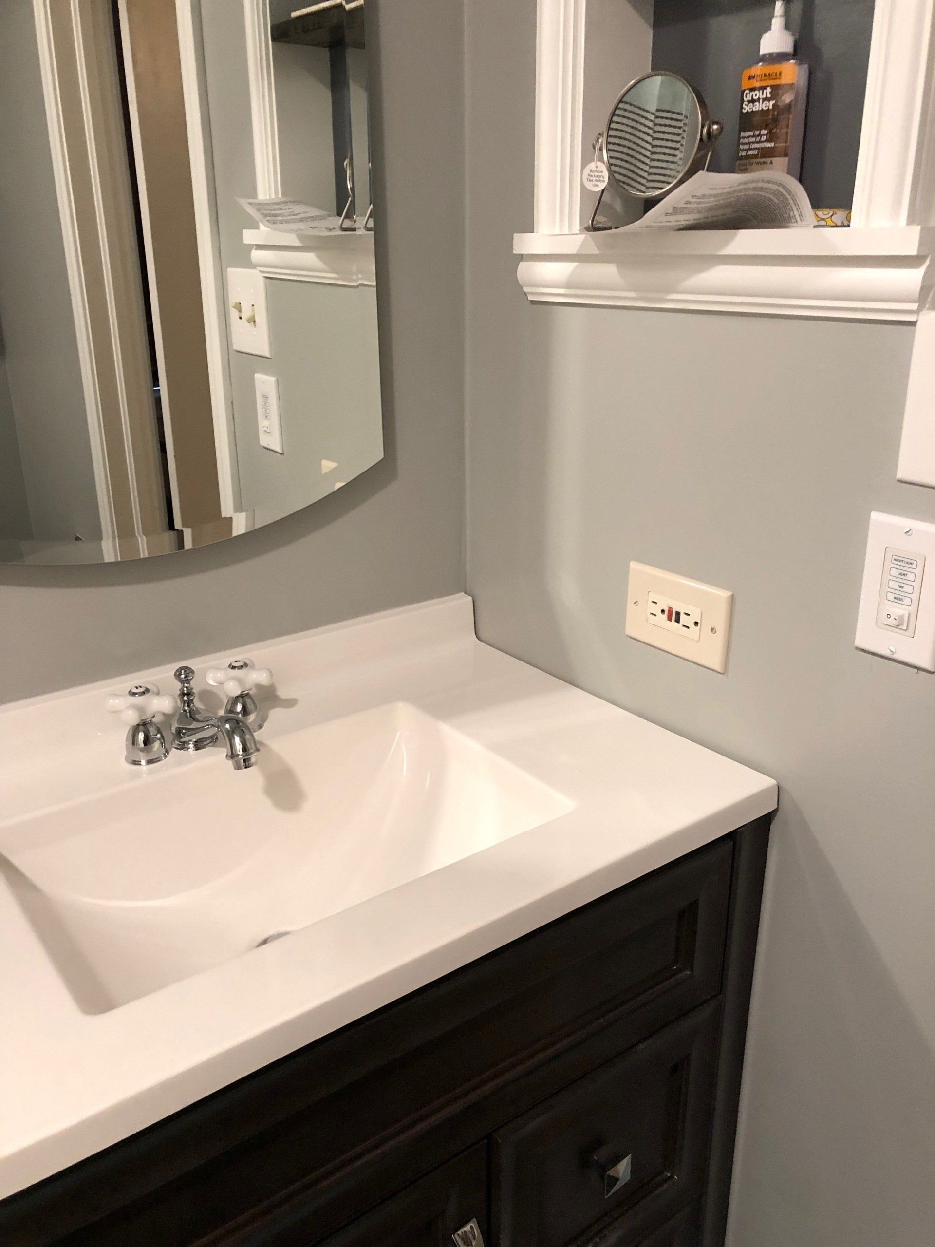 A bathroom with a sink and a mirror.