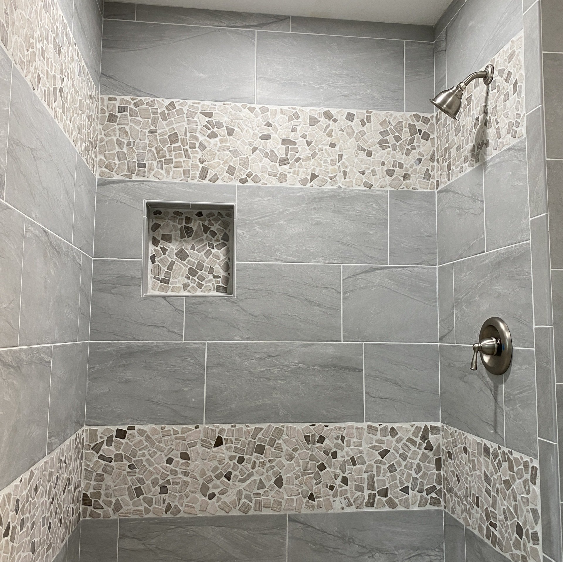 Shower tile installed, decorative tile, rock tile, shampoo shelf