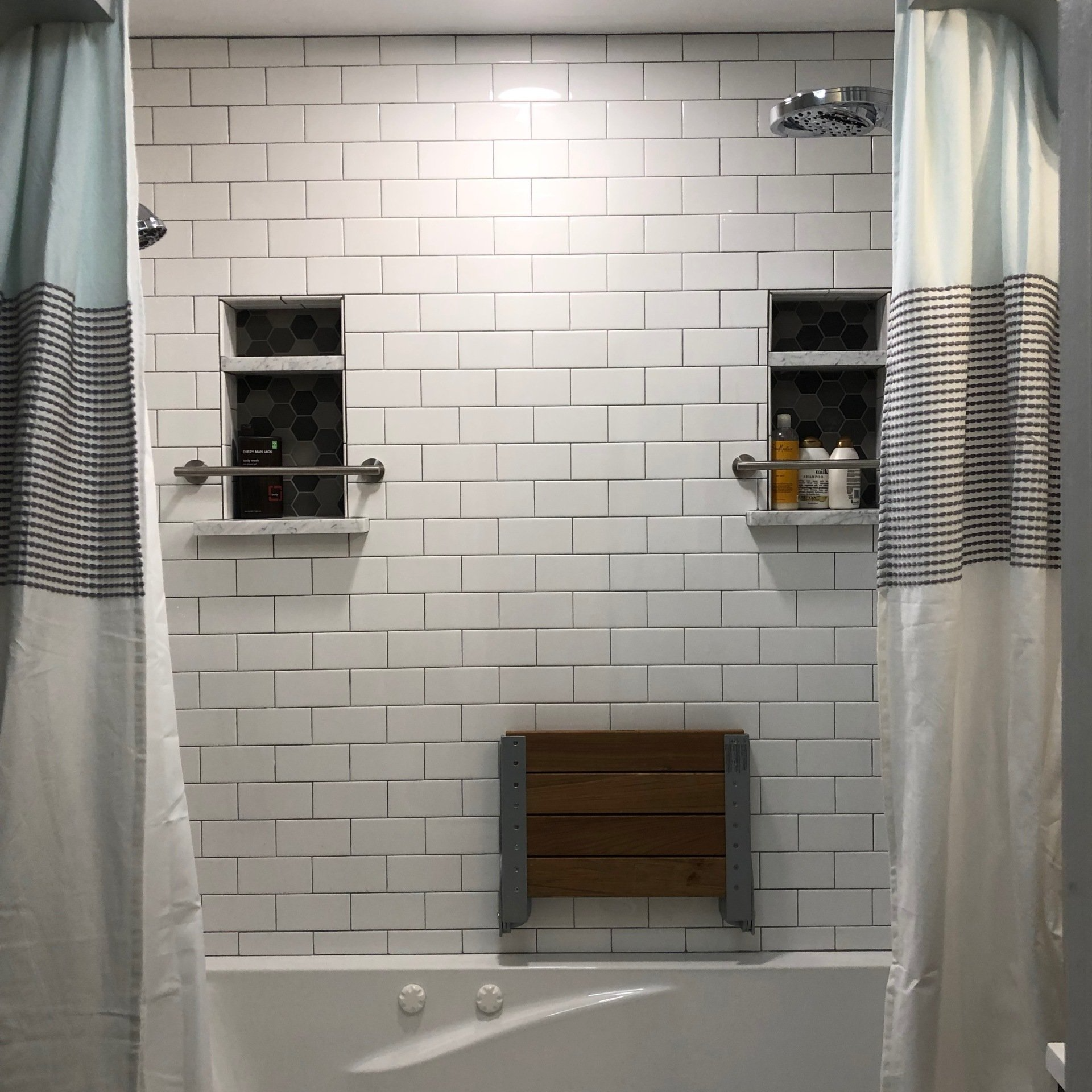 A bathroom with white brick walls and a bathtub