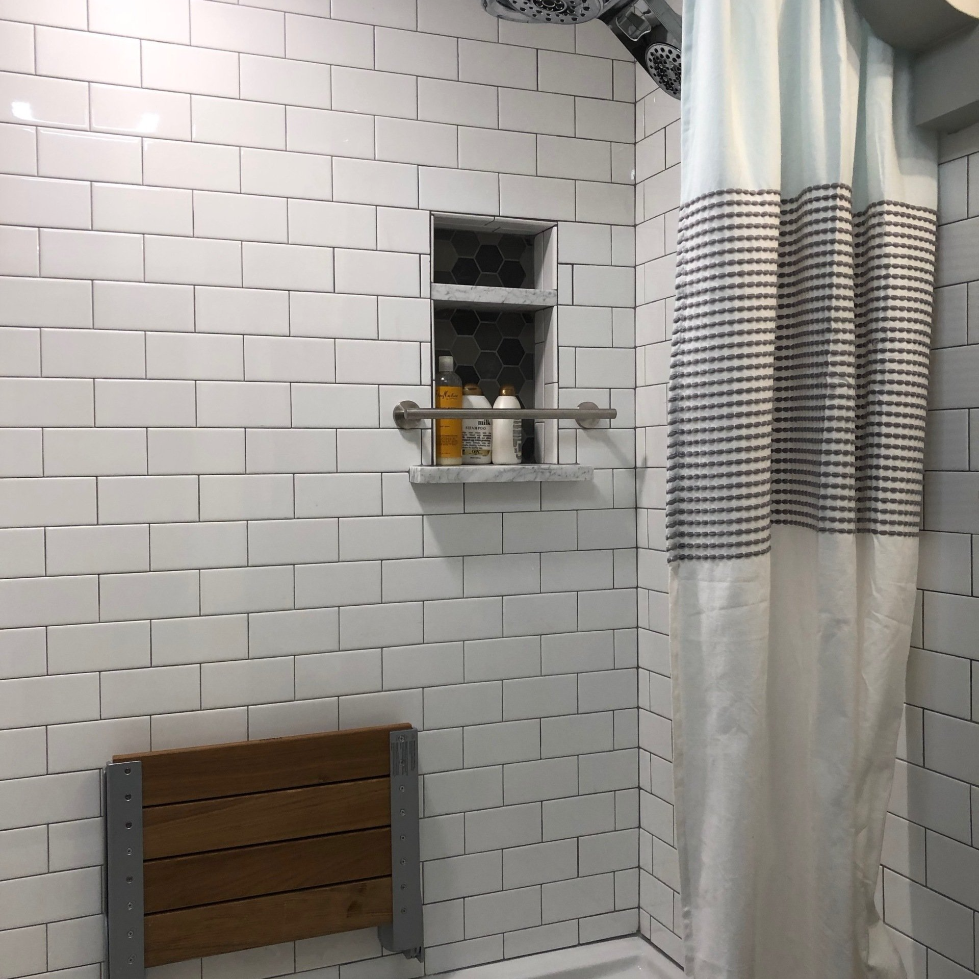 Bathtub with ceramic tile, shower seat and shampoo shelf