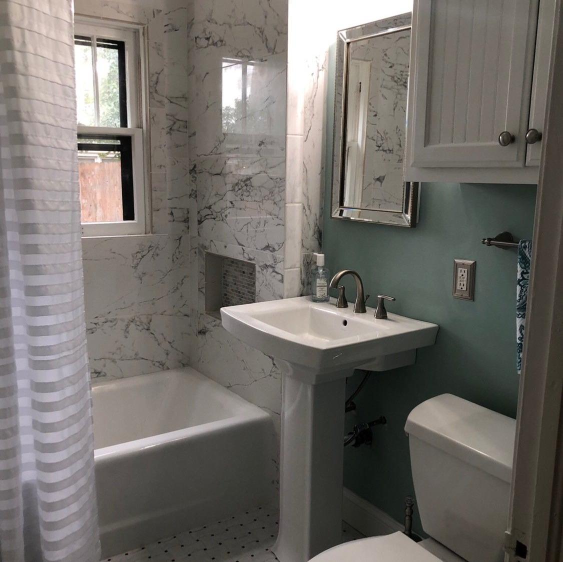 A bathroom with a sink a toilet and a bathtub