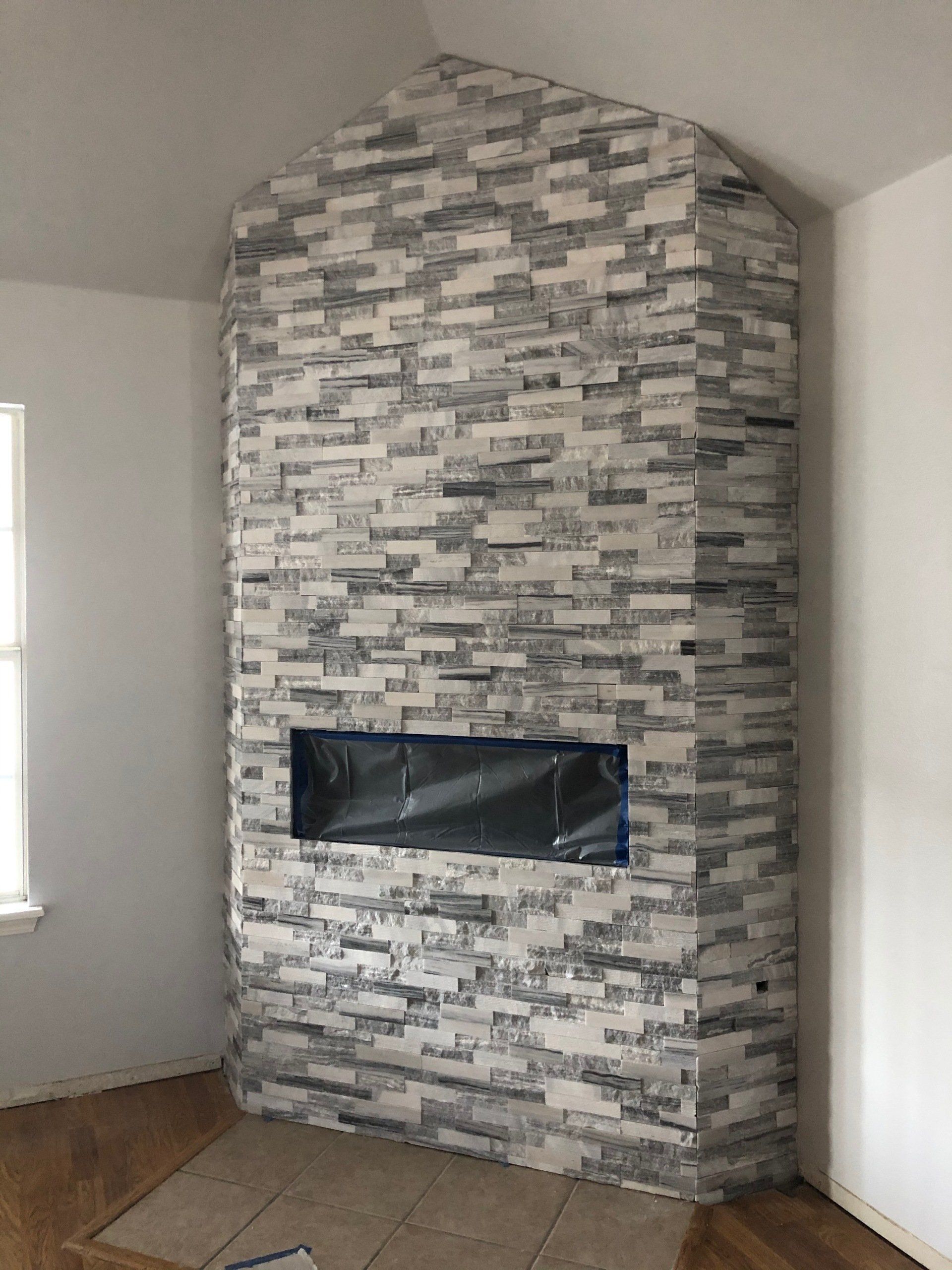 There is a fireplace in the corner of the room.