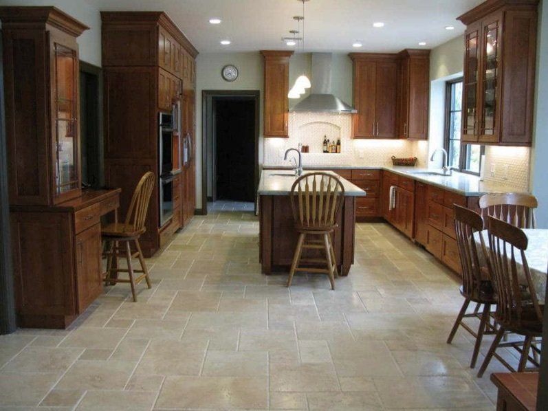 A kitchen with wooden cabinets and a large island