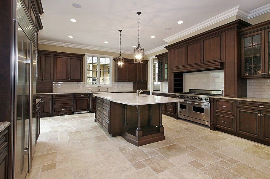 A large kitchen with stainless steel appliances and wooden cabinets