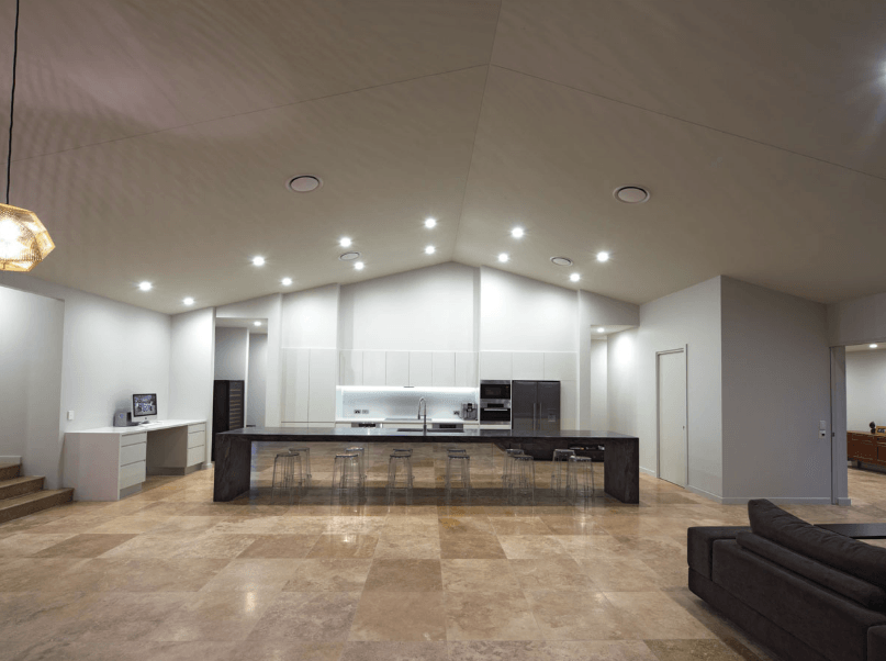 A large living room with a kitchen and a couch.