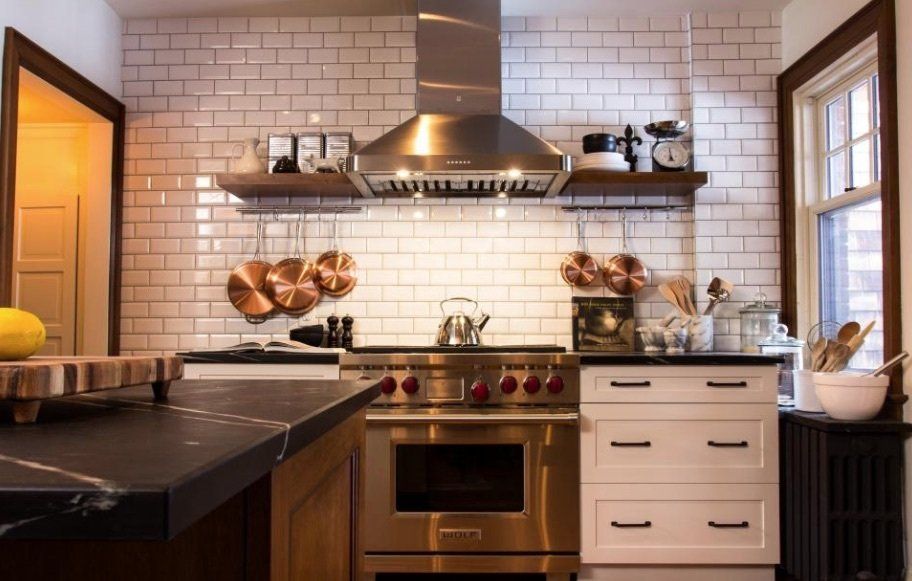 A kitchen with stainless steel appliances and white cabinets