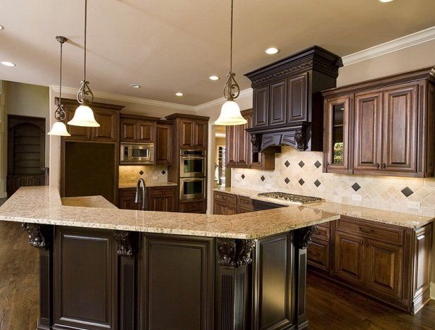 A kitchen with wooden cabinets and granite counter tops