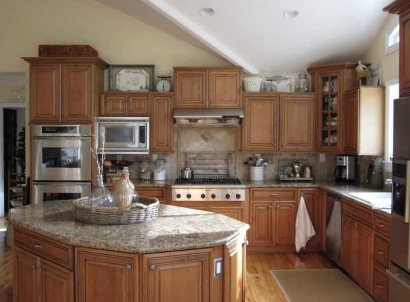 A kitchen with wooden cabinets and granite counter tops