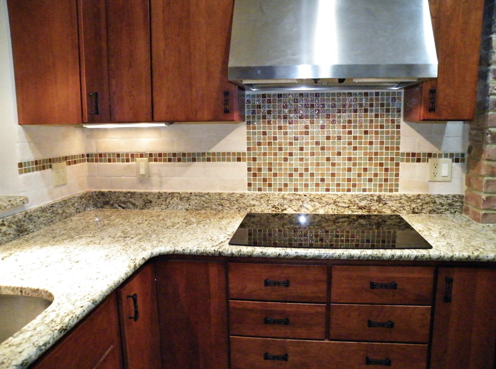 A kitchen with stainless steel appliances and wooden cabinets