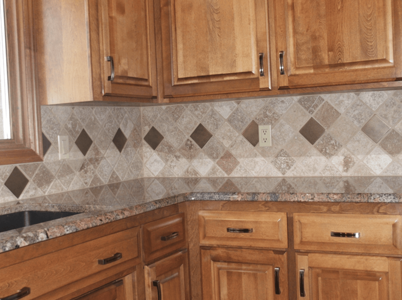 A kitchen with wooden cabinets and granite counter tops