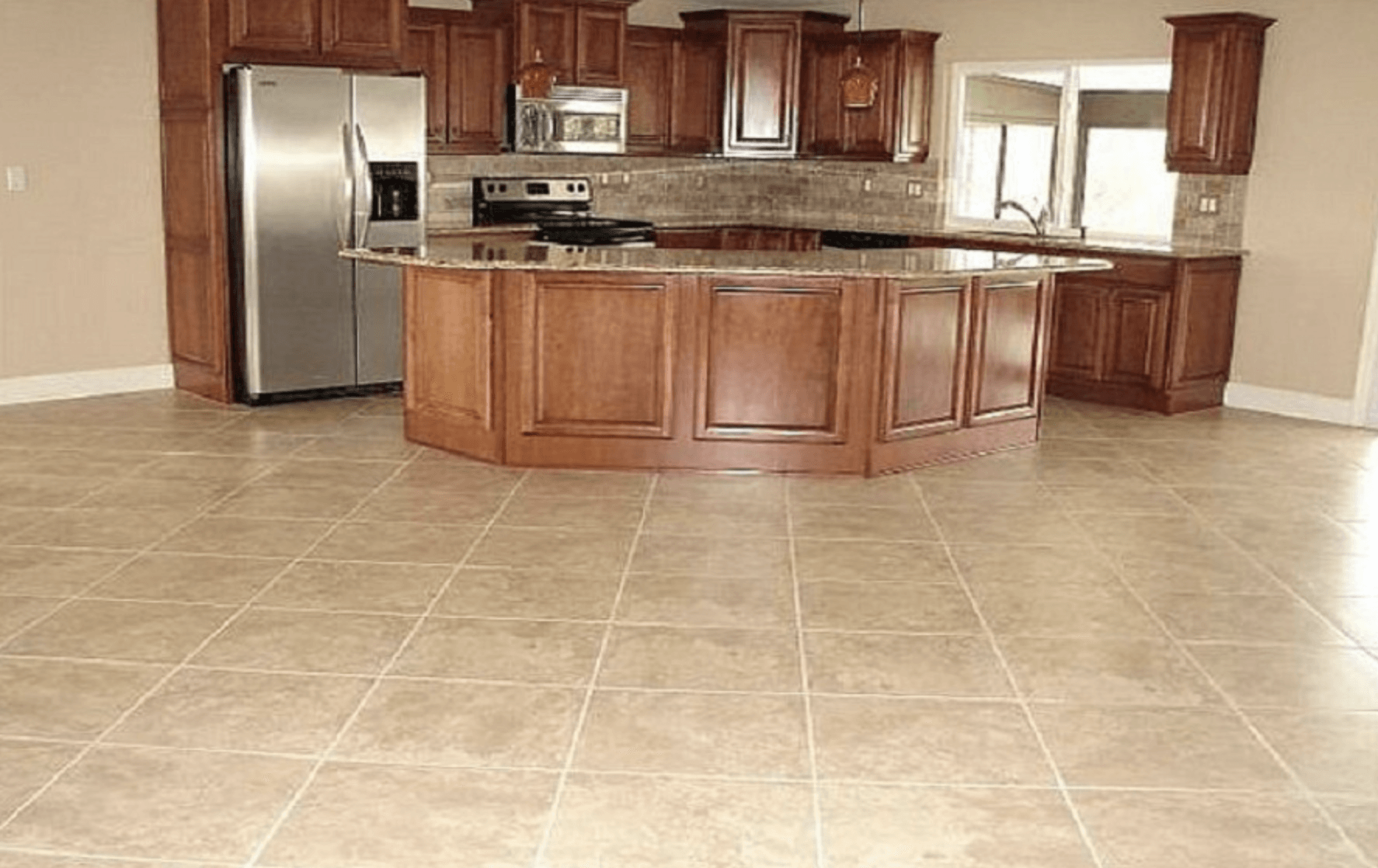 A kitchen with stainless steel appliances and wooden cabinets.