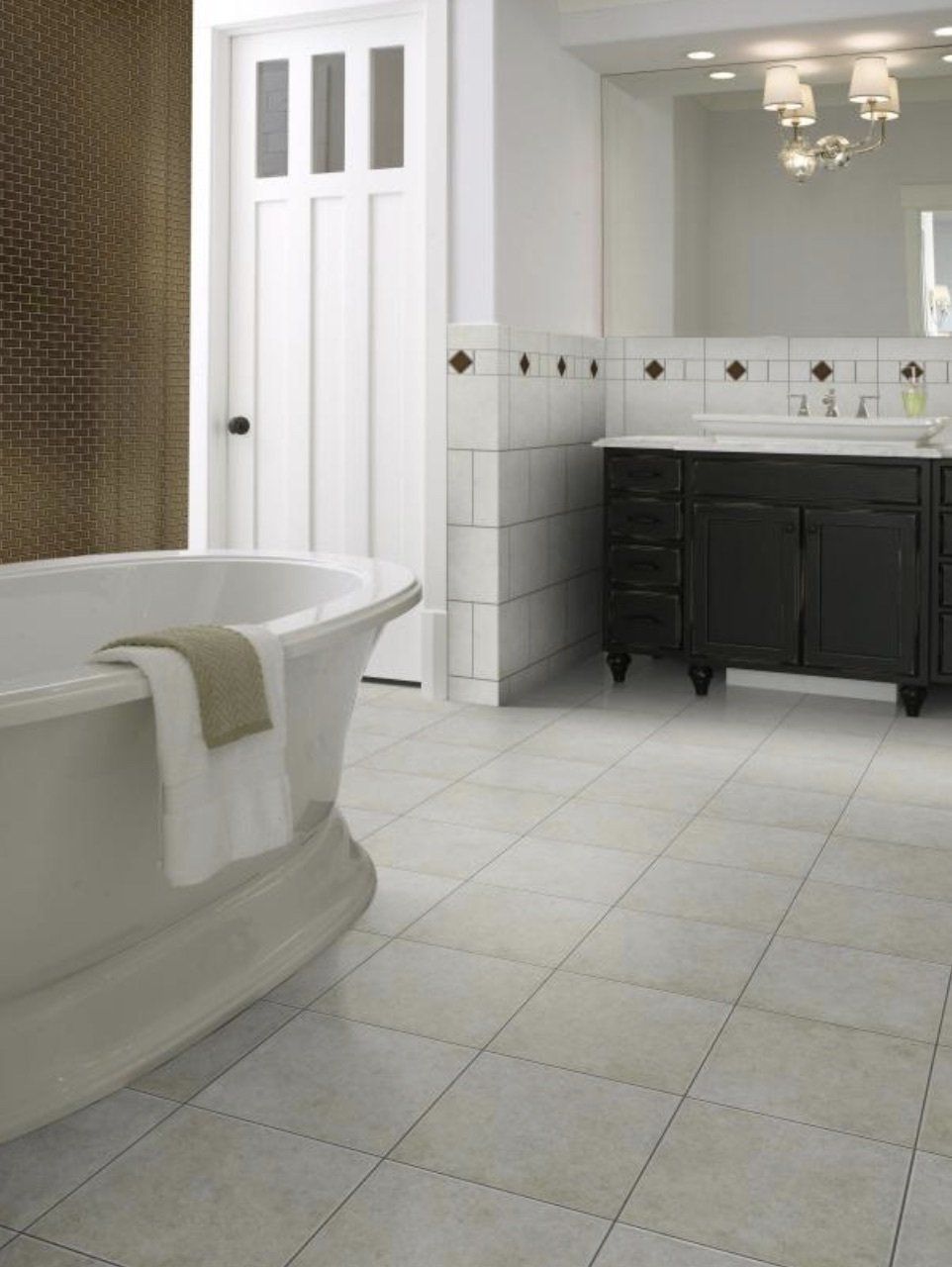 A bathroom with a tub , sink and mirror