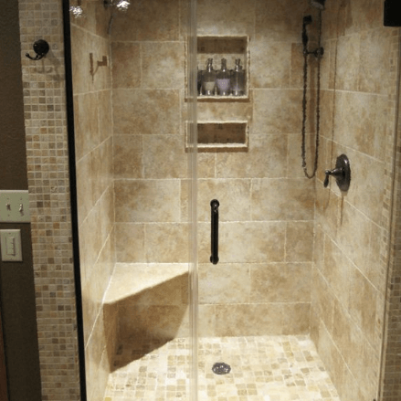 Marble tile shower with shower seat and shampoo shelves